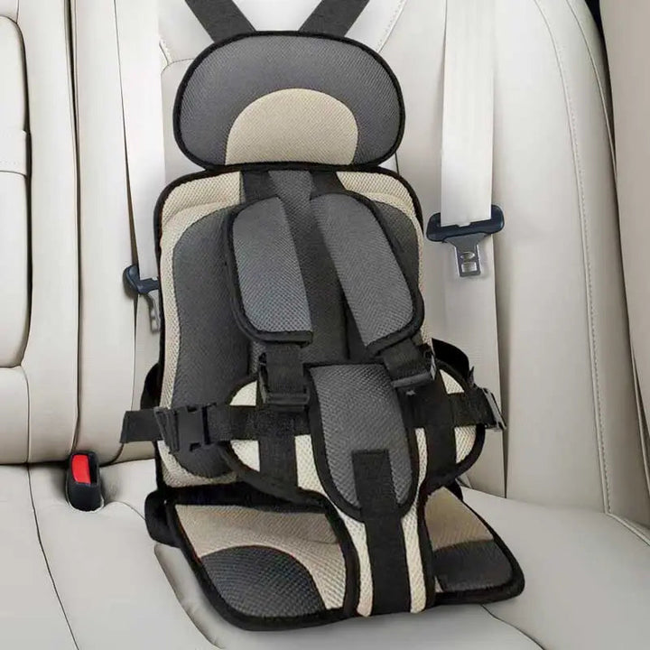 Child car cushion seat in red for ages 0-12, showcasing soft, compact design and secure restraints for safe, comfortable trav