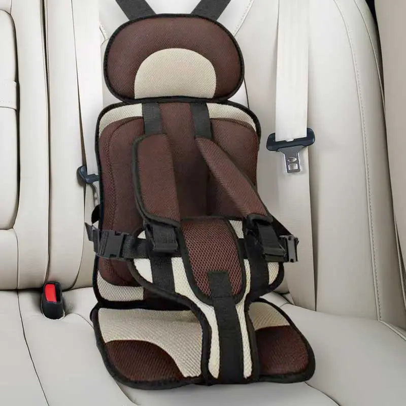 Child car cushion seat in red for ages 0-12, showcasing soft, compact design and secure restraints for safe, comfortable trav