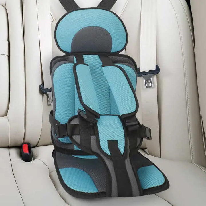 Child car cushion seat in red for ages 0-12, showcasing soft, compact design and secure restraints for safe, comfortable trav