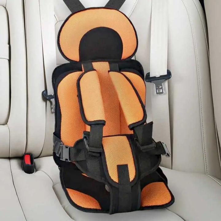 Child car cushion seat in red for ages 0-12, showcasing soft, compact design and secure restraints for safe, comfortable trav