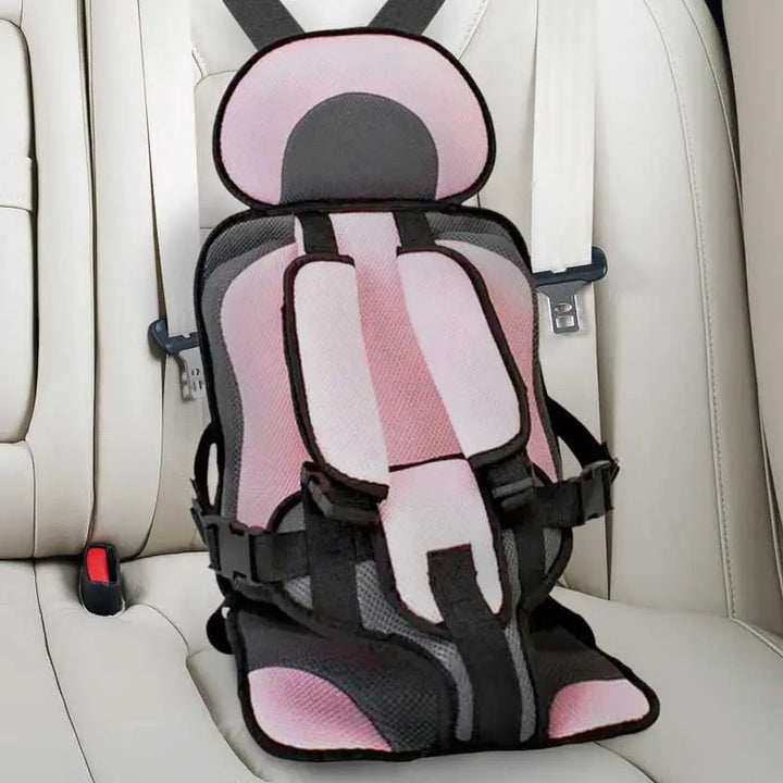 Child car cushion seat in red for ages 0-12, showcasing soft, compact design and secure restraints for safe, comfortable trav