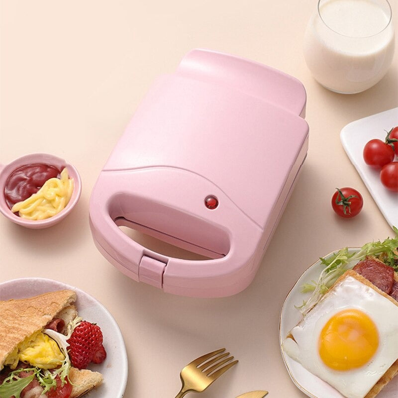 Compact 2-in-1 non-stick sandwich maker & toaster, sleek design, cooks 2 slices, even heating, perfect for small kitchens.