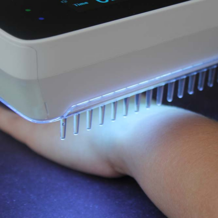 "Compact handheld UVB phototherapy lamp for psoriasis, vitiligo treatment; ideal for scalp, hands, joints; travel-friendly."