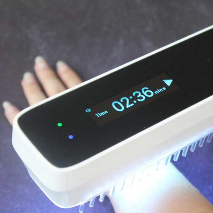 "Compact handheld UVB phototherapy lamp for psoriasis, vitiligo treatment; ideal for scalp, hands, joints; travel-friendly."