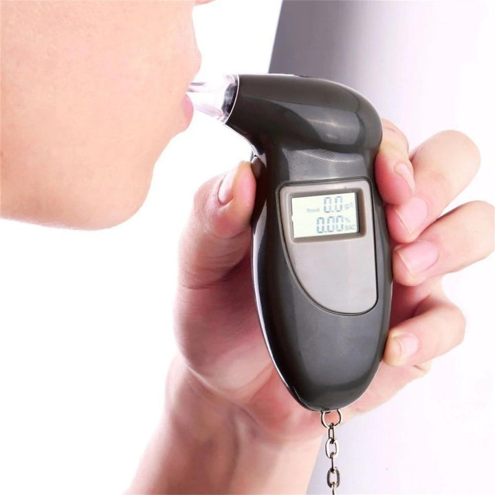"Compact portable breathalyzer with LCD display and key ring for accurate alcohol testing; essential for personal safety."