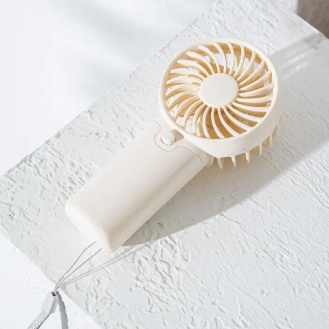 "Compact portable mini fan, sleek design in white, pocket-sized cooler for travel or office, beauty wellbeing essential."