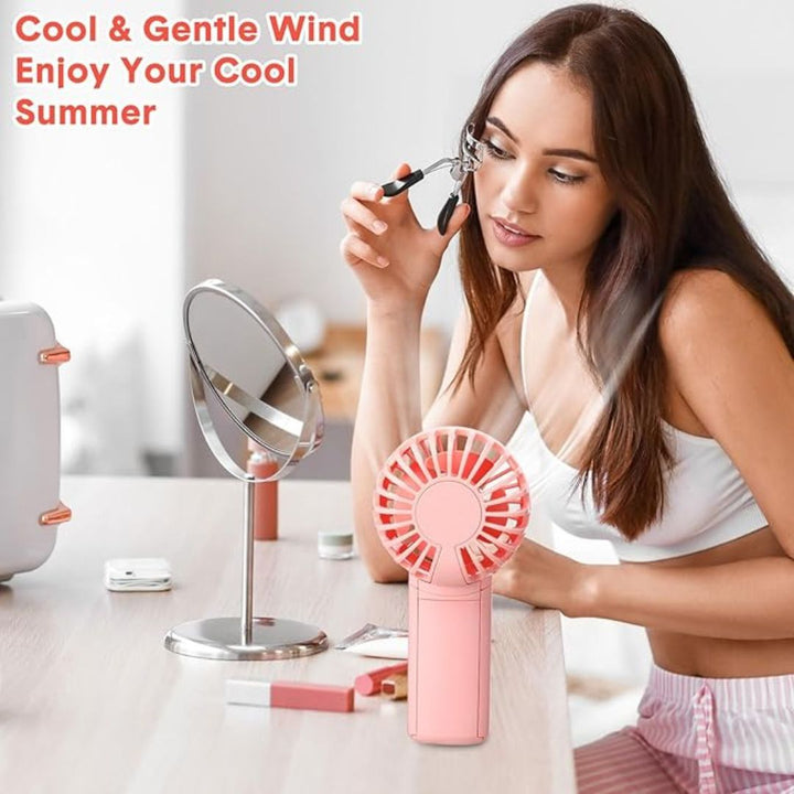 "Compact portable mini fan, sleek design in white, pocket-sized cooler for travel or office, beauty wellbeing essential."