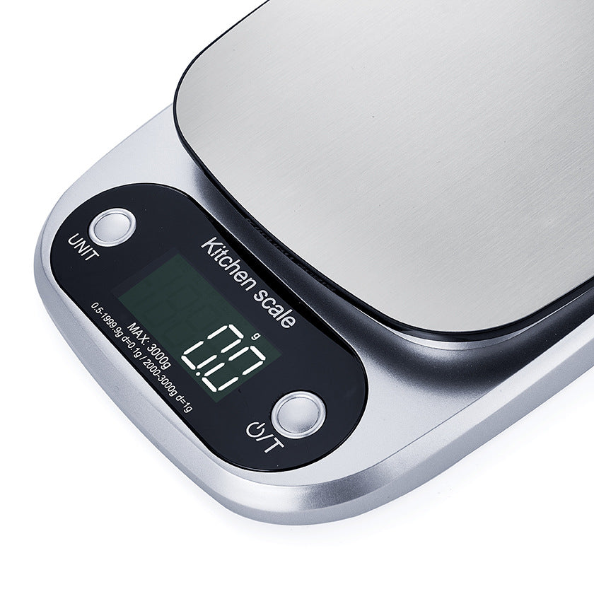"Compact stainless steel kitchen scale with sleek design for precise 0.1g measurements, ideal for culinary accuracy."