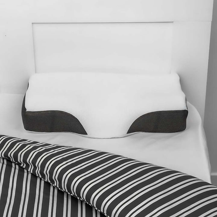 "Contoured memory foam neck pillow for pain relief, featuring spinal alignment support; ideal for better sleep."