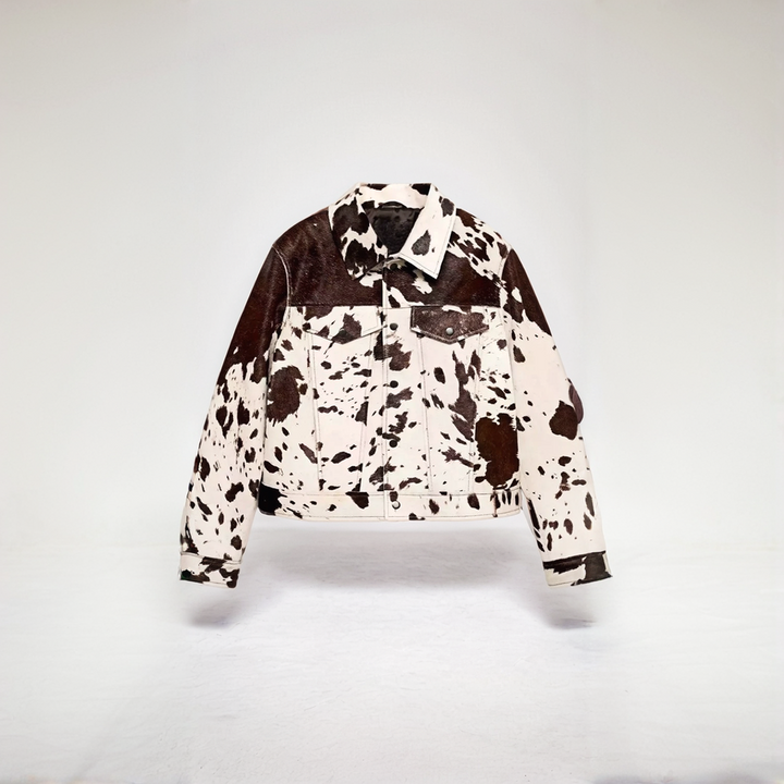 Cow print structured jacket, front view, single-breasted design, black and white pattern, women's fashion statement piece.