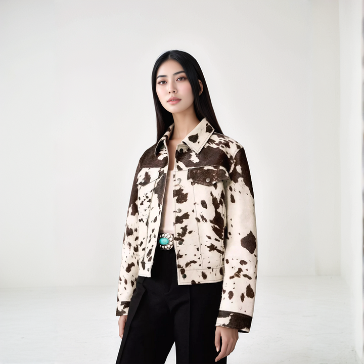 Cow print structured jacket, front view, single-breasted design, black and white pattern, women's fashion statement piece.