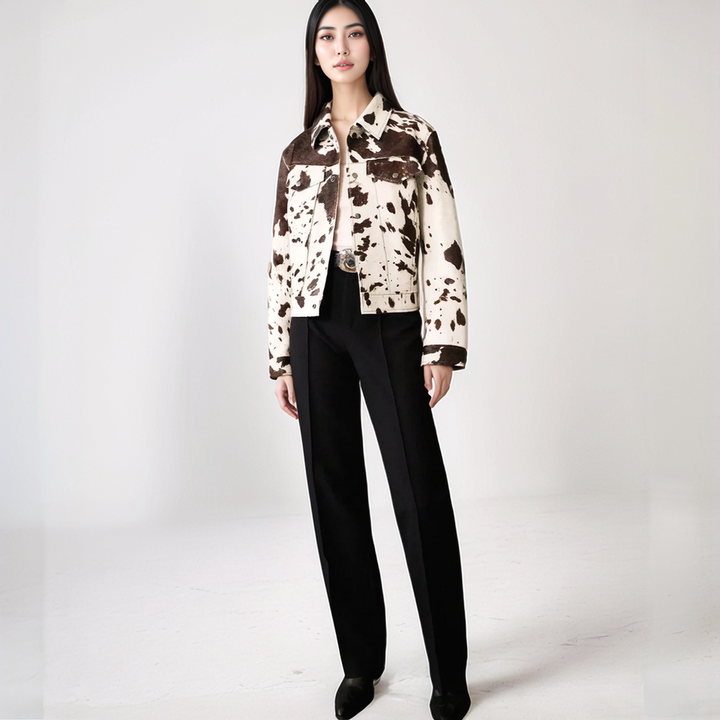 Cow print structured jacket, front view, single-breasted design, black and white pattern, women's fashion statement piece.