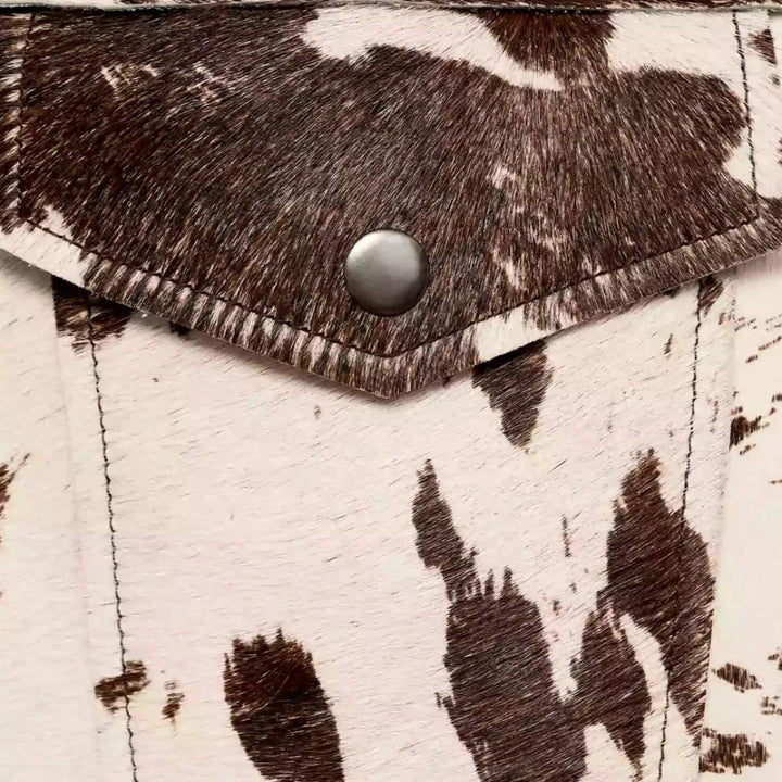 Cow print structured jacket, front view, single-breasted design, black and white pattern, women's fashion statement piece.