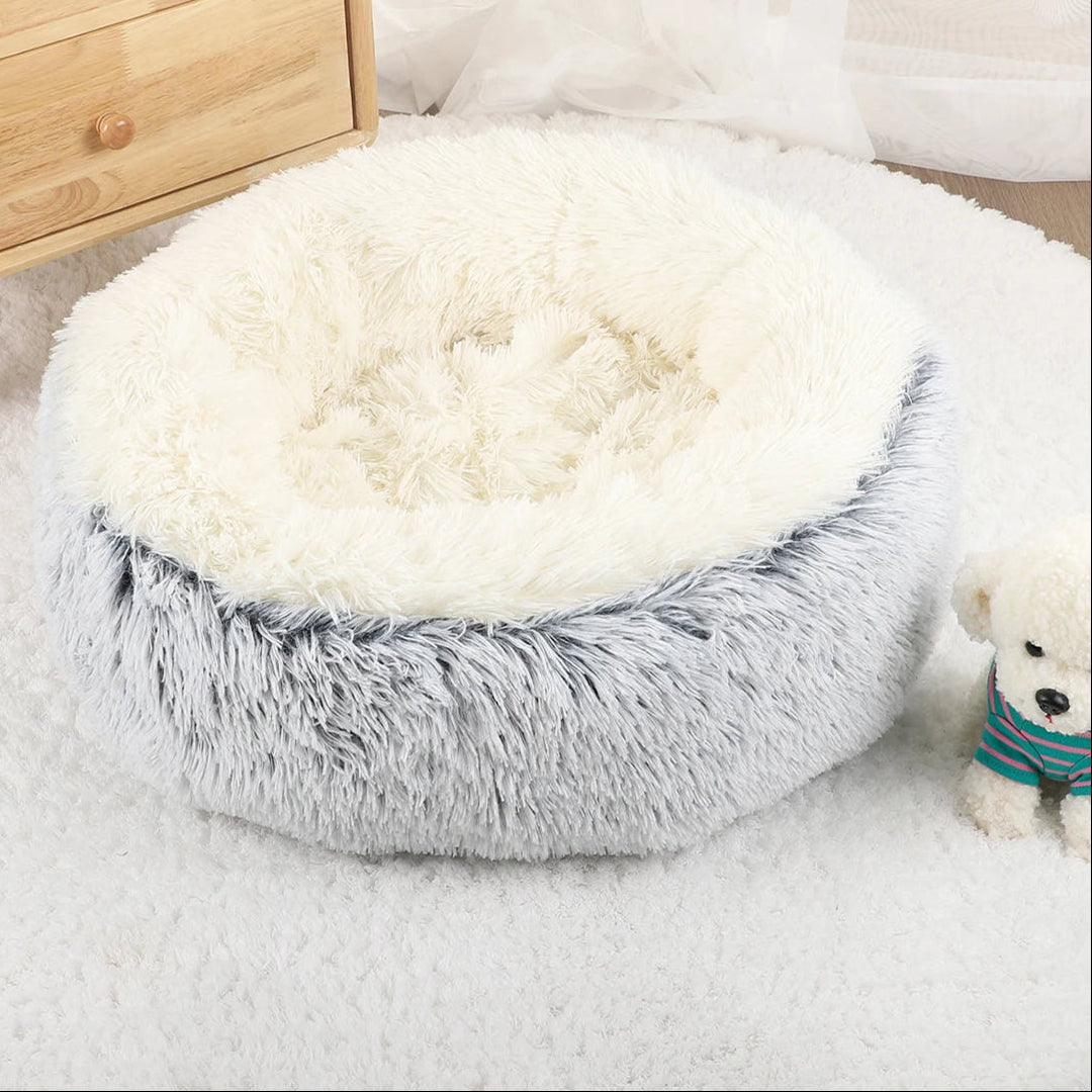 "Cozy plush donut dog bed with deep sides, faux fur, circular shape for comfort and anxiety relief in various sizes."