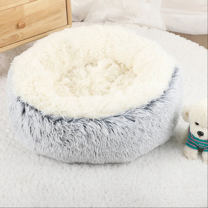 "Cozy plush donut dog bed with deep sides, faux fur, circular shape for comfort and anxiety relief in various sizes."