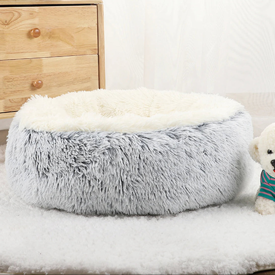 "Cozy plush donut dog bed with deep sides, faux fur, circular shape for comfort and anxiety relief in various sizes."