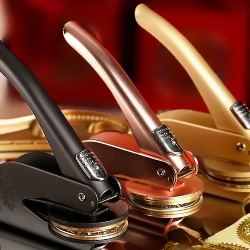 "Custom Library Embosser, brass tool with elegant design, perfect for personalizing books, cards, and stationery."