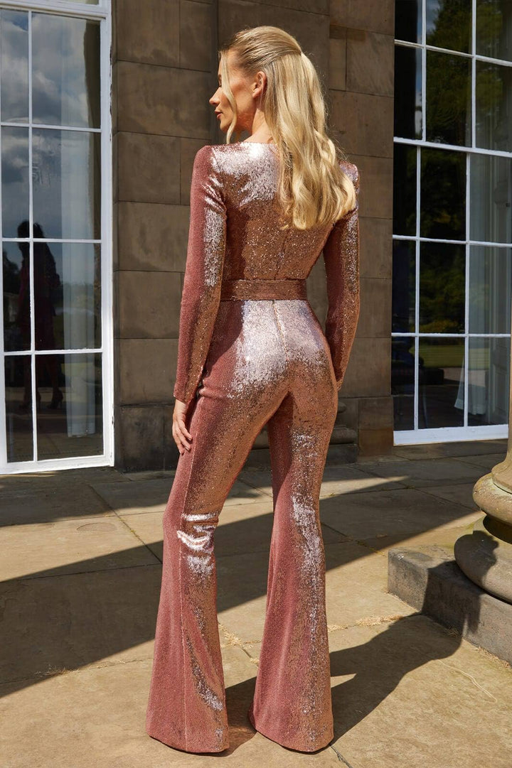 Dazzling women's long sleeve sequin jumpsuit with flared legs, perfect for evening events and dramatic style.