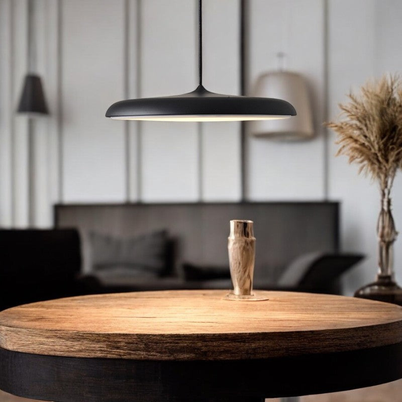 "Disc-shaped Scandinavian pendant light with LED, metal & acrylic materials, in elegant minimalist design for modern décor."