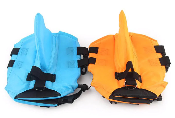 "Dog life jacket with shark fin, vibrant colors, adjustable straps, ensures pet safety and buoyancy in water adventures."