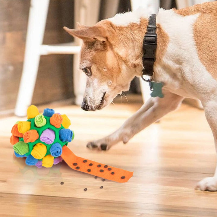 Dog's interactive snuffle treat ball in blue, green, and red, made of plush fleece and durable rubber for engaging playtime.