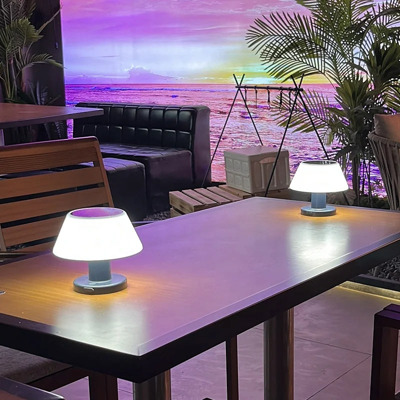 Eco-friendly solar-powered LED table lamp with sleek modern design for indoor and outdoor use; durable and waterproof.