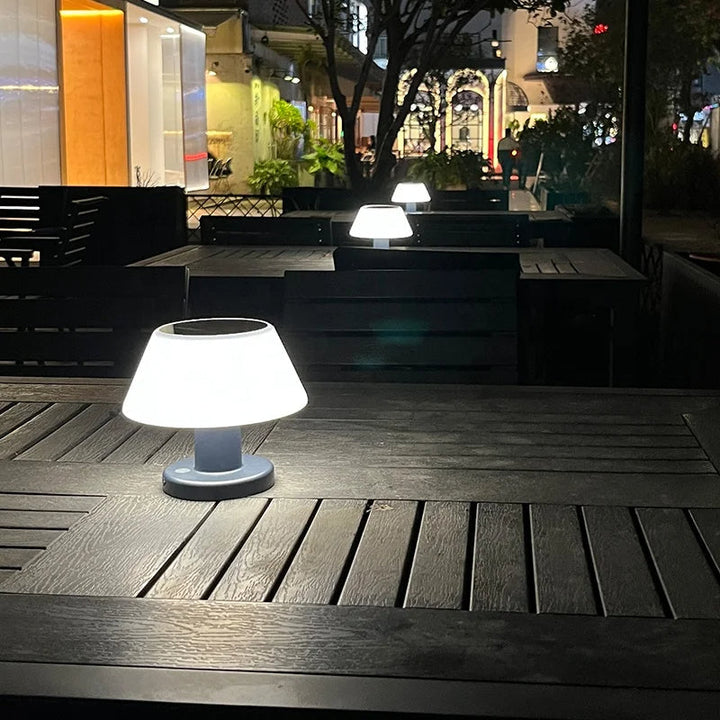 Eco-friendly solar-powered LED table lamp with sleek modern design for indoor and outdoor use; durable and waterproof.