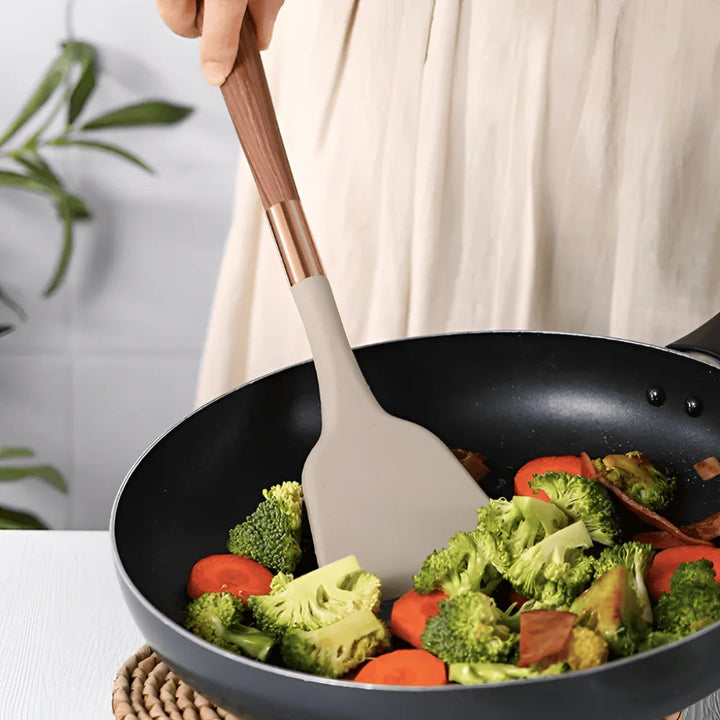 Elegant 10-piece silicone utensil set, heat resistant, features ergonomic handles, minimalist design for modern kitchens.