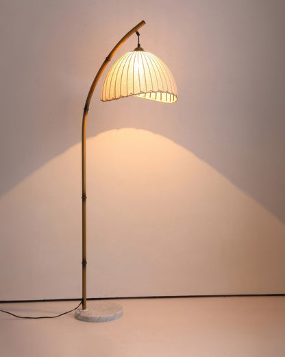 Elegant bamboo floor lamp with fabric shade, offering ambient lighting for a relaxing ambiance in home decor settings.