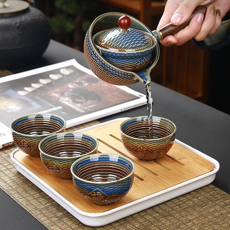 "Elegant ceramic rotating Japanese tea pot set with infuser, showcasing handcrafted artistry and traditional design in blue."