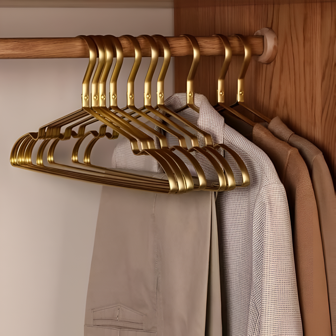 "Elegant gold and silver anti-slip clothes hangers with velvet finish, slim design, and 360° chrome swivel hook in closet."
