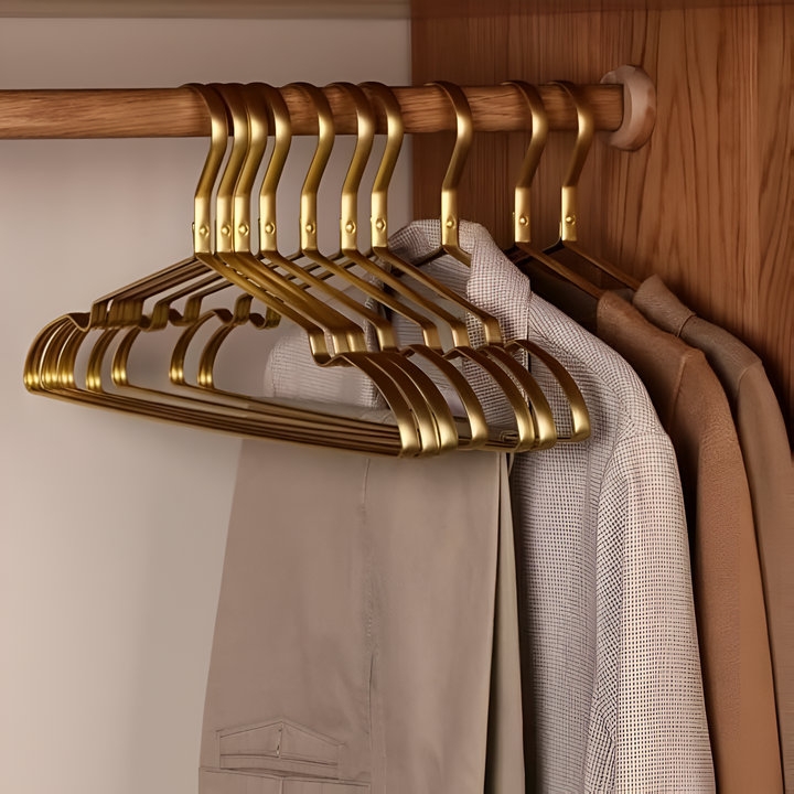 "Elegant gold and silver anti-slip clothes hangers with velvet finish, slim design, and 360° chrome swivel hook in closet."