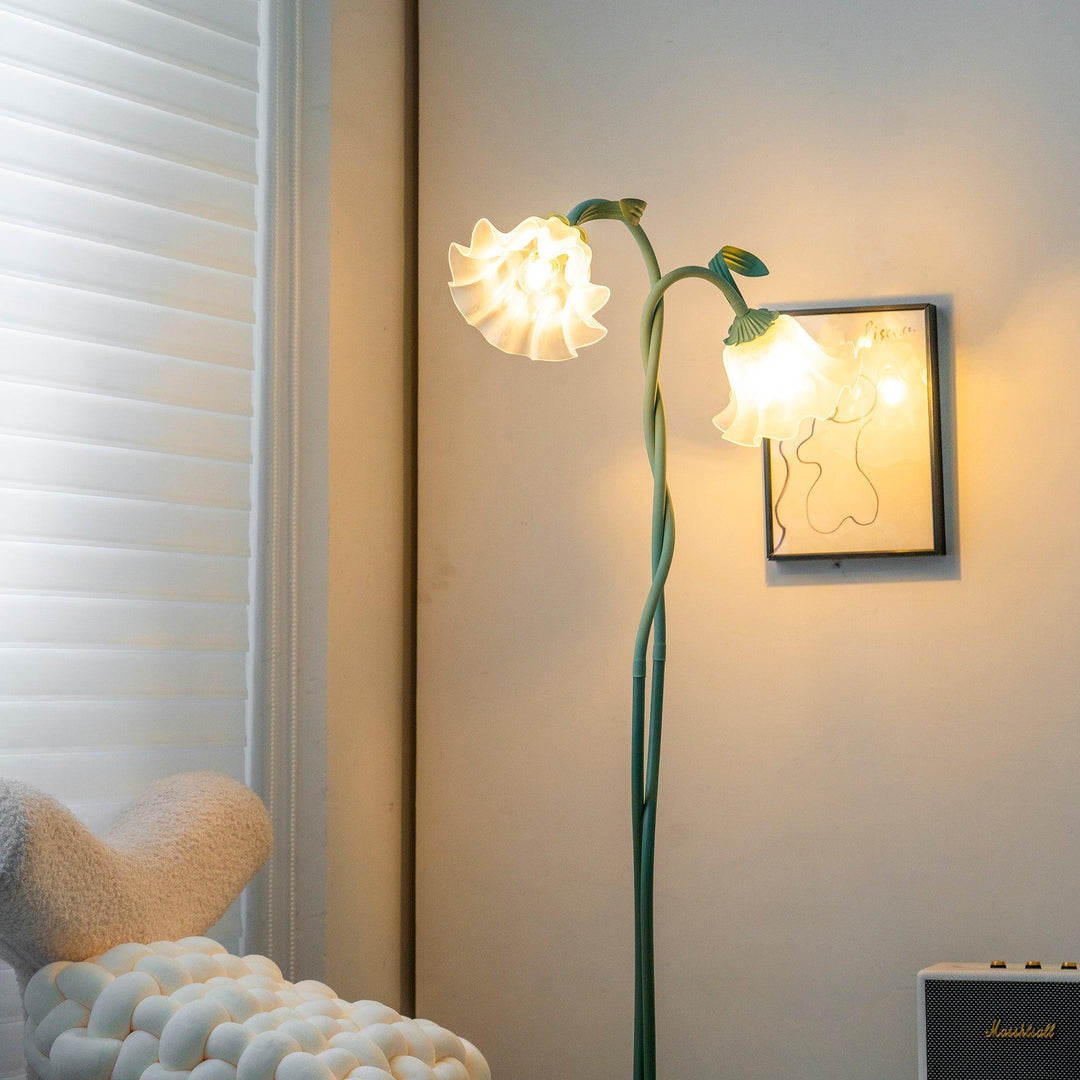 Elegant green floor lamp with white calla flower accents, matte finish, and metal construction, enhancing home decor.