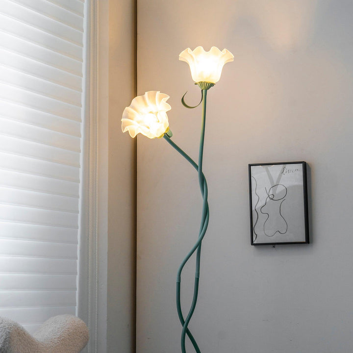 Elegant green floor lamp with white calla flower accents, matte finish, and metal construction, enhancing home decor.