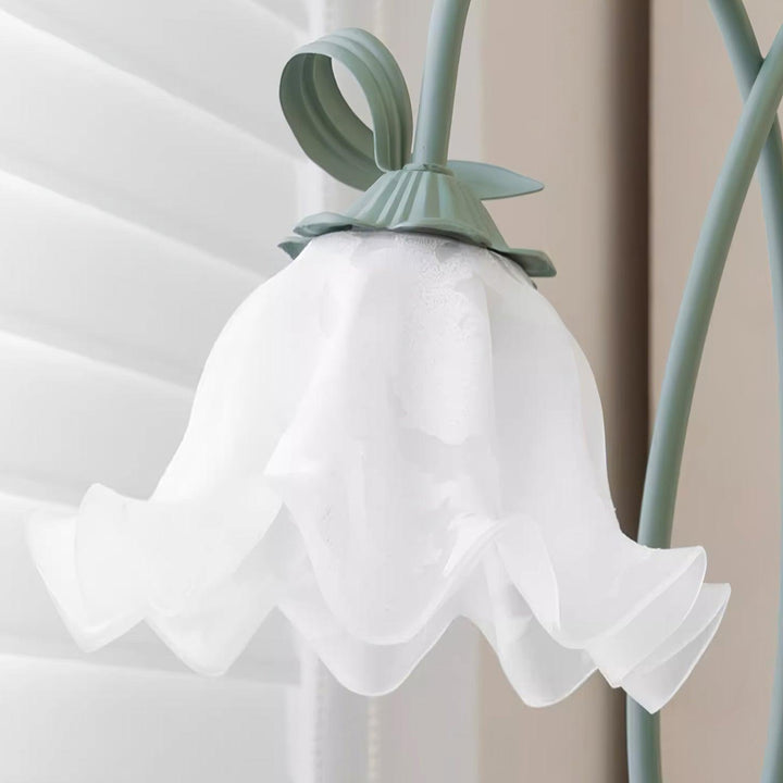 Elegant green floor lamp with white calla flower accents, matte finish, and metal construction, enhancing home decor.