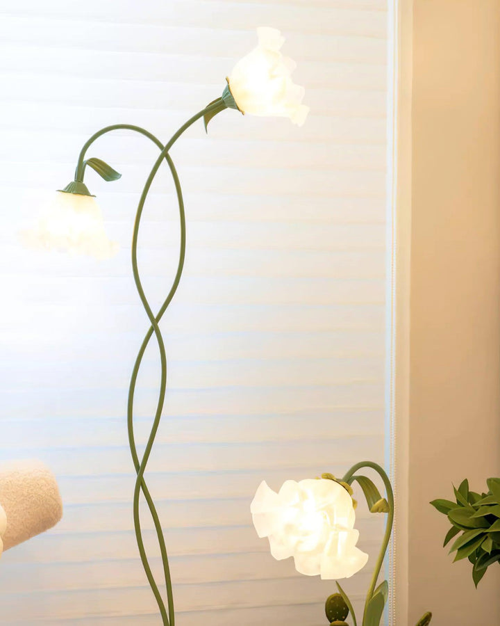 Elegant green floor lamp with white calla flower accents, matte finish, and metal construction, enhancing home decor.