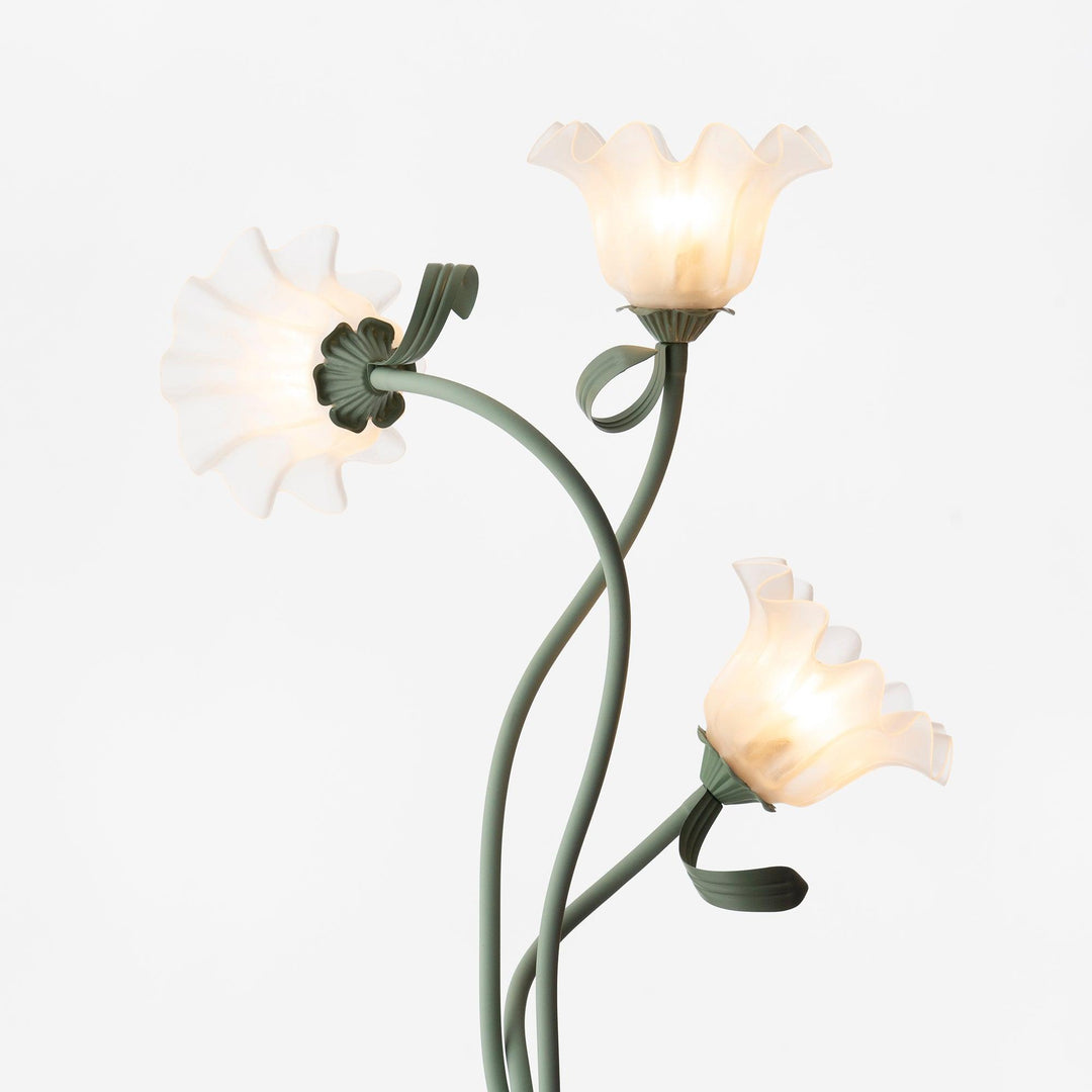 Elegant green floor lamp with white calla flower accents, matte finish, and metal construction, enhancing home decor.