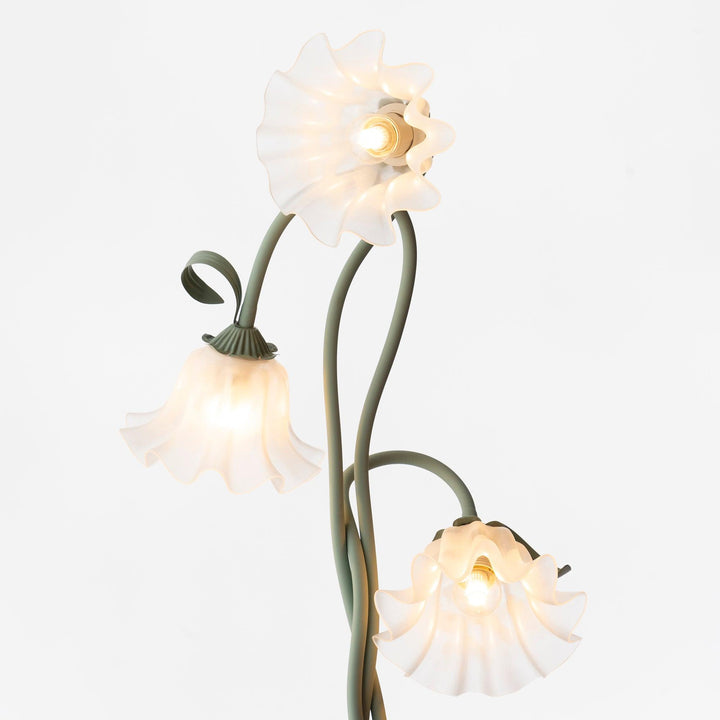 Elegant green floor lamp with white calla flower accents, matte finish, and metal construction, enhancing home decor.