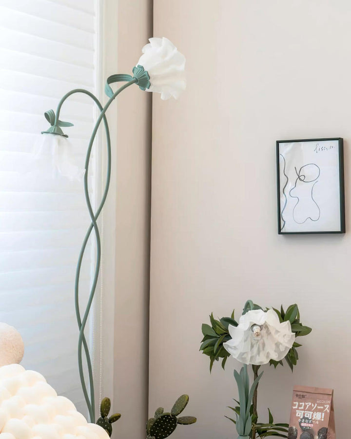 Elegant green floor lamp with white calla flower accents, matte finish, and metal construction, enhancing home decor.