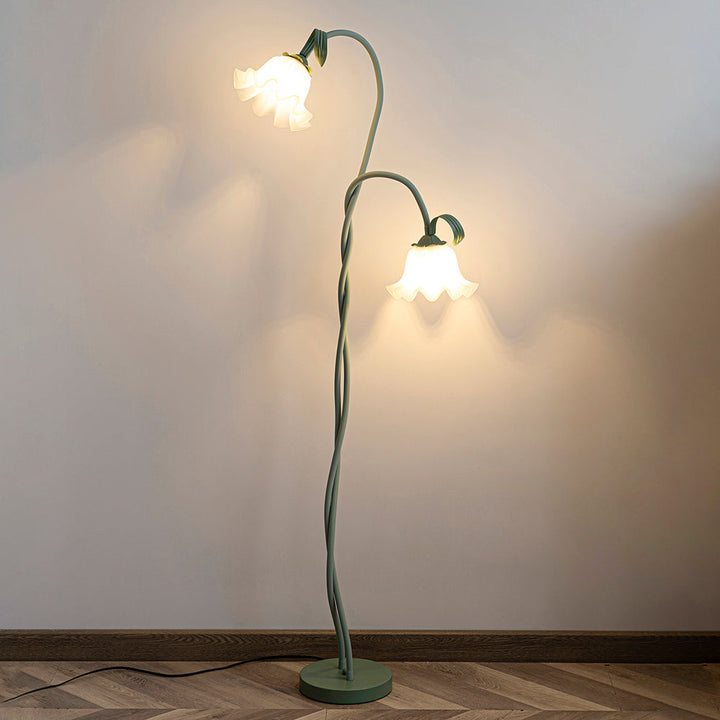 Elegant green floor lamp with white calla flower accents, matte finish, and metal construction, enhancing home decor.