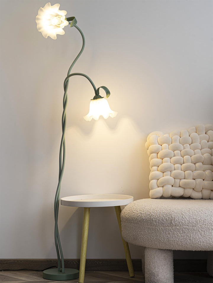 Elegant green floor lamp with white calla flower accents, matte finish, and metal construction, enhancing home decor.