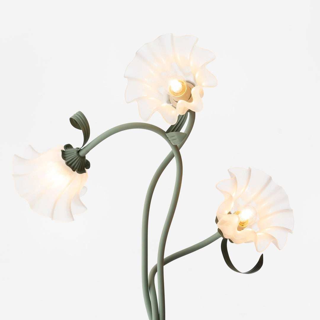 Elegant green floor lamp with white calla flower accents, matte finish, and metal construction, enhancing home decor.