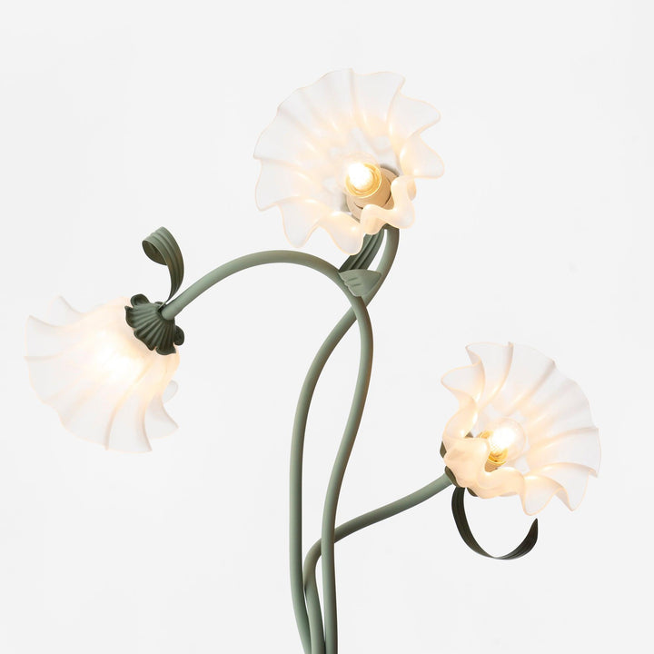 Elegant green floor lamp with white calla flower accents, matte finish, and metal construction, enhancing home decor.