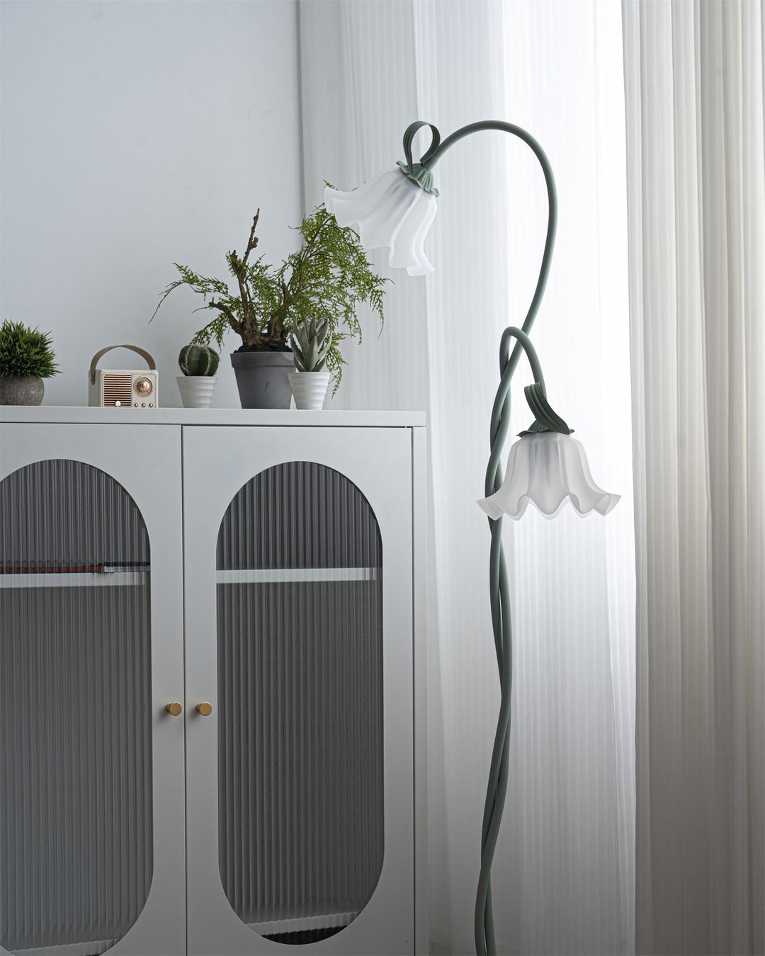 Elegant green floor lamp with white calla flower accents, matte finish, and metal construction, enhancing home decor.