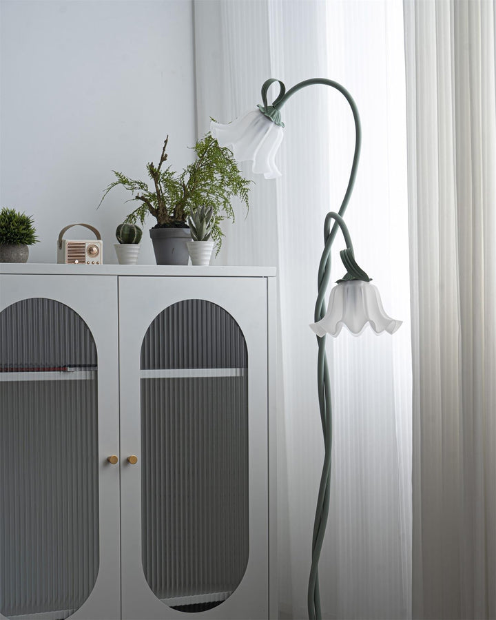 Elegant green floor lamp with white calla flower accents, matte finish, and metal construction, enhancing home decor.