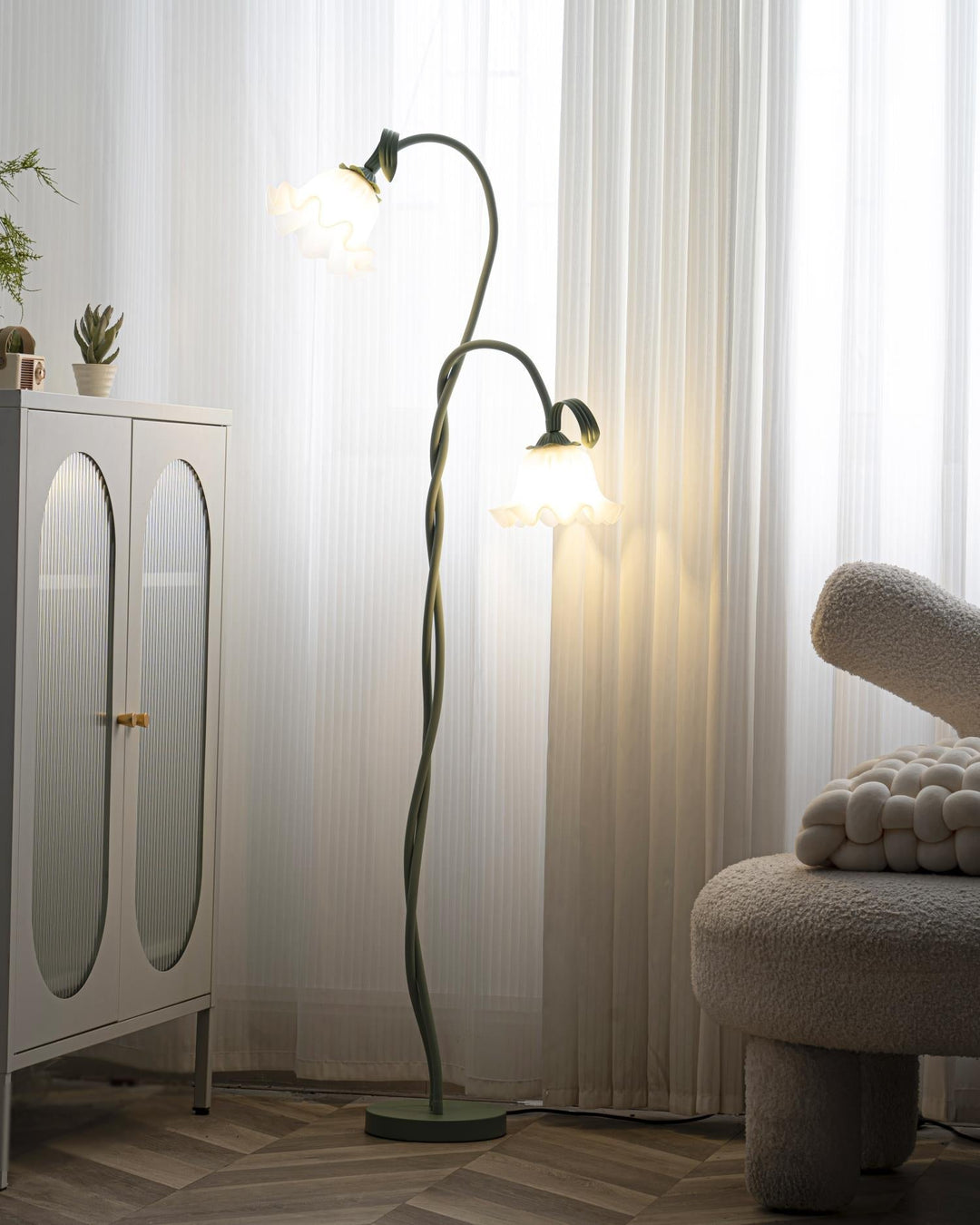 Elegant green floor lamp with white calla flower accents, matte finish, and metal construction, enhancing home decor.
