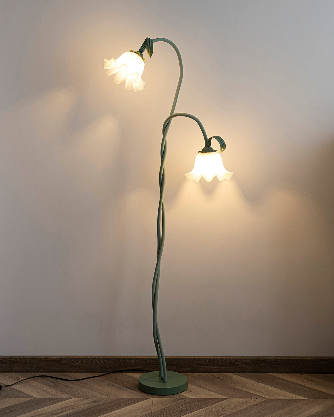 Elegant green floor lamp with white calla flower accents, matte finish, and metal construction, enhancing home decor.