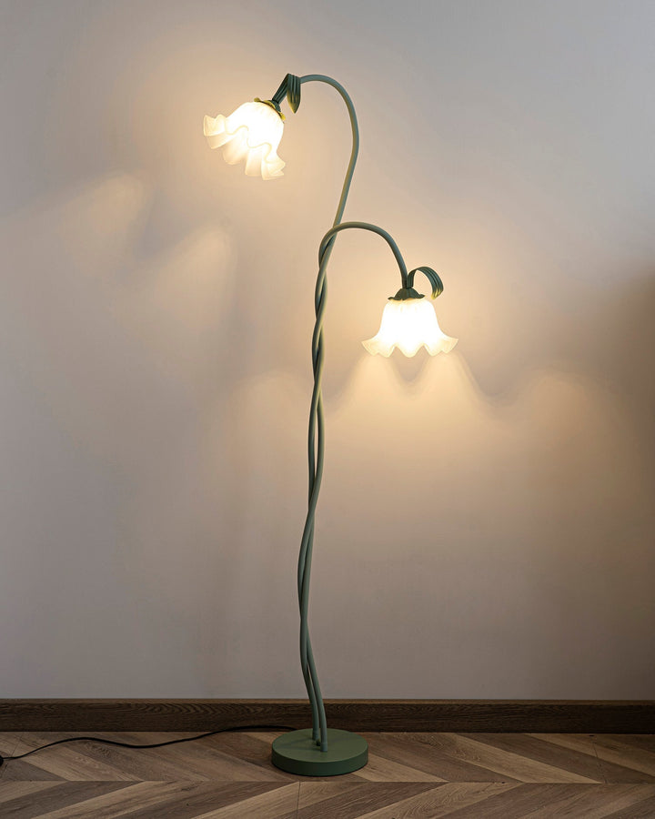 Elegant green floor lamp with white calla flower accents, matte finish, and metal construction, enhancing home decor.
