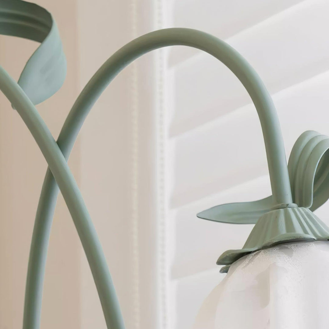 Elegant green floor lamp with white calla flower accents, matte finish, and metal construction, enhancing home decor.