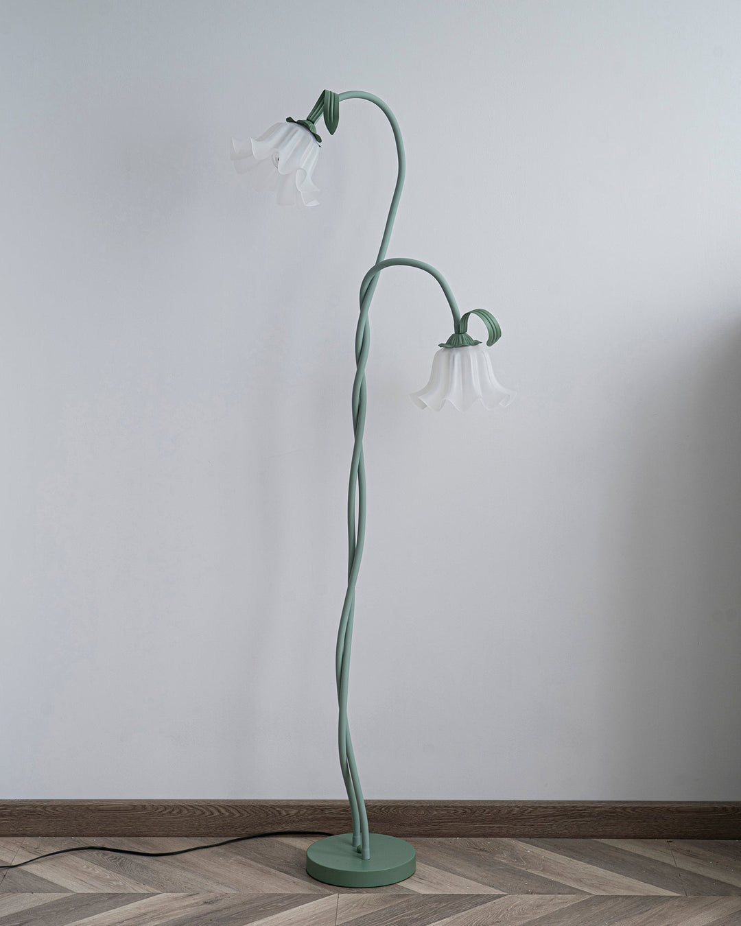 Elegant green floor lamp with white calla flower accents, matte finish, and metal construction, enhancing home decor.